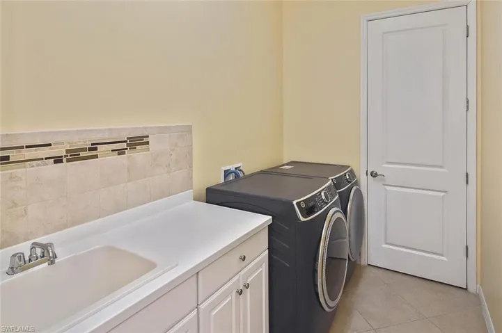 Laundry Room with utility sink, storage, and washer and dryer