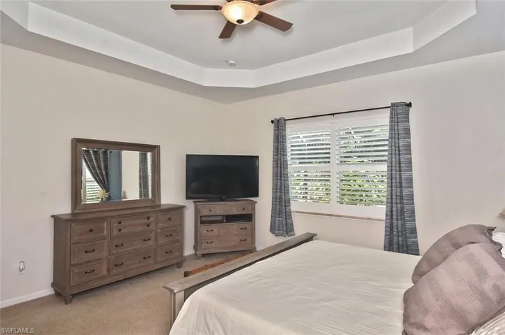 Spacious and Bright Primary Bedroom with large double window and Plantation Shutters.