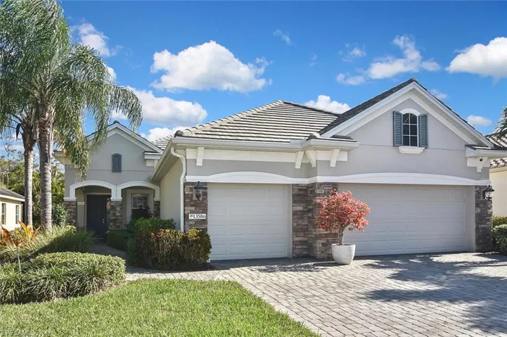 View of front of home featuring paver drive and walk way and stone facade