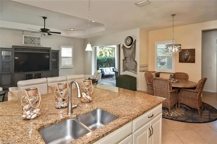 Light and Bright  Kitchen has double stainless sink and attractive granite counters.