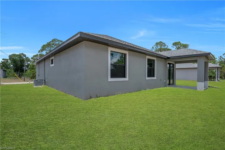 Expansive green lawn surrounds the property