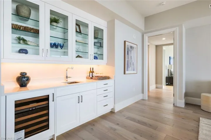 Wet Bar with Dual Zone Wine Cooler and Custom Glass Front Cabinetry