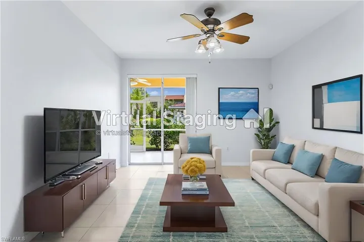 Living room with ceiling fan and light tile patterned flooring