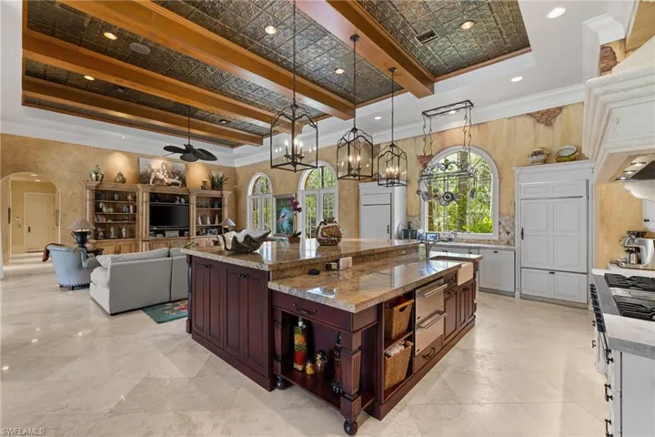 Kitchen island with granite countertop, integrated storage, and undermount sink