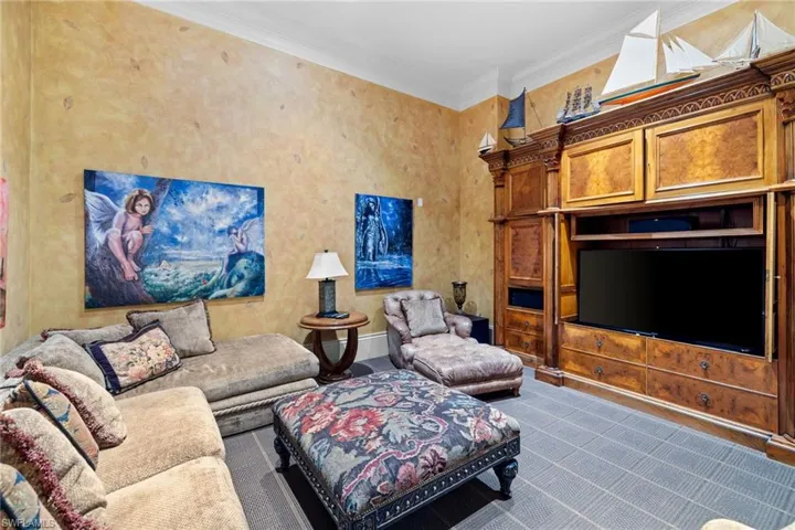 Built-in entertainment center featuring multiple storage cabinets and drawers