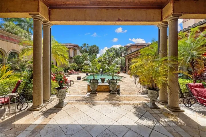 Courtyard with a central fountain and surrounding tropical landscaping