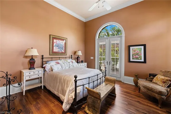 Room featuring high ceilings, crown molding, and wood-finish flooring