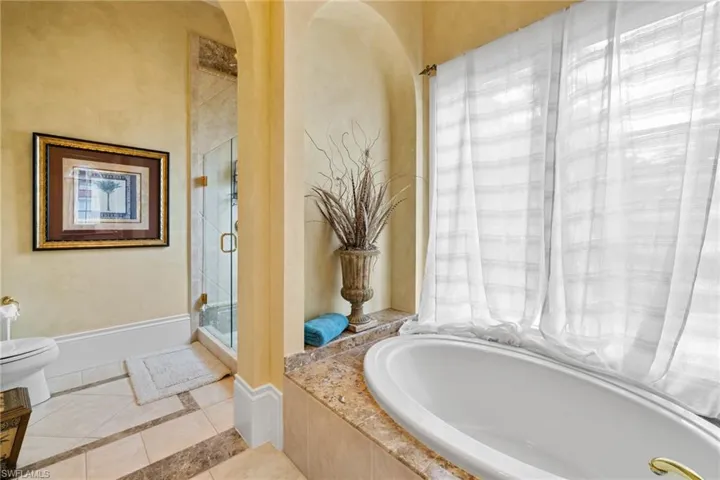 Soaking tub with a polished stone surround and expansive window