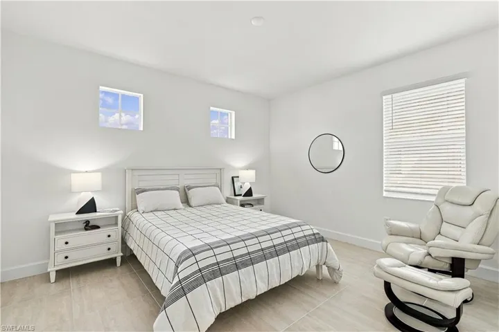 Bright interior with light-colored tile flooring, white walls, and a recessed ceiling light