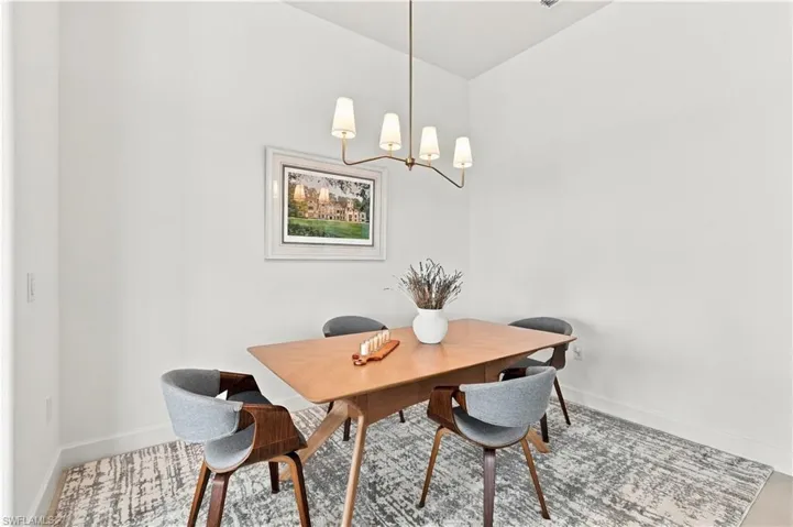 Recessed ceiling lighting and a contemporary chandelier illuminate the space