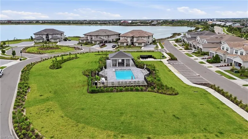 Community pool with a covered pavilion, surrounded by a paved deck