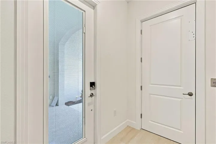 White paneled interior door with a bronze lever handle