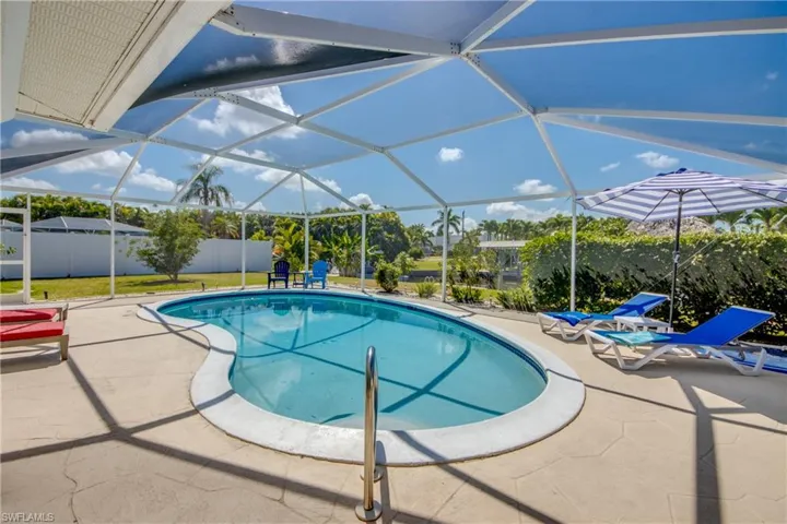 View of pool with a patio area and a lanai