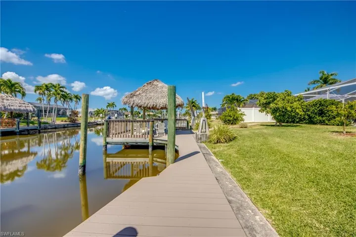 View of dock featuring a water view and a yard