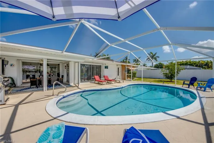View of swimming pool with a lanai and a patio area