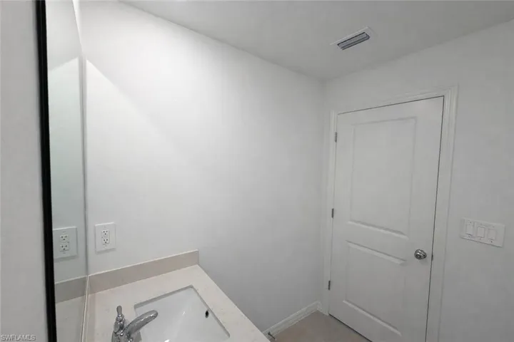 Bathroom with vanity and baseboards
