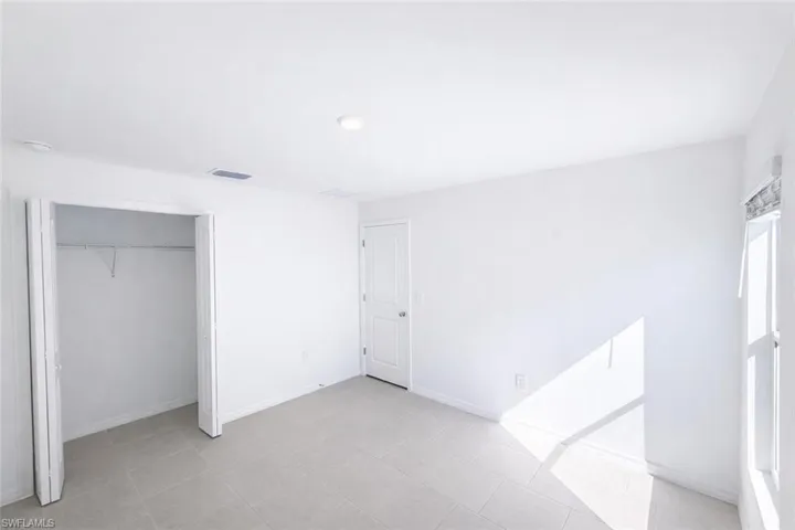 Unfurnished bedroom featuring baseboards and a closet