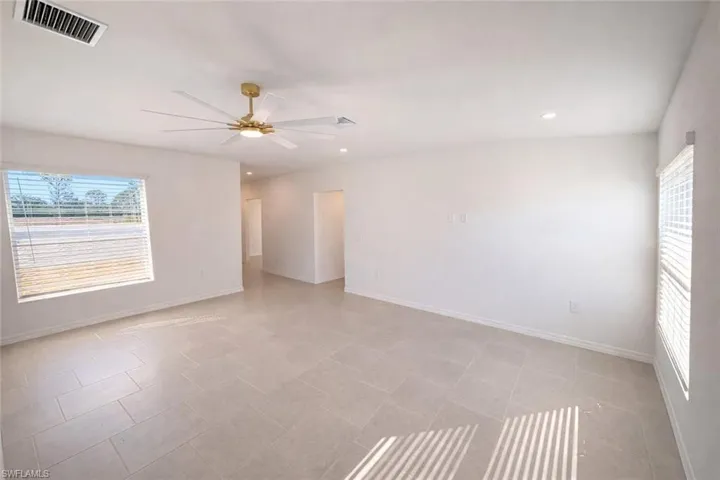 Empty room featuring a ceiling fan and recessed lighting