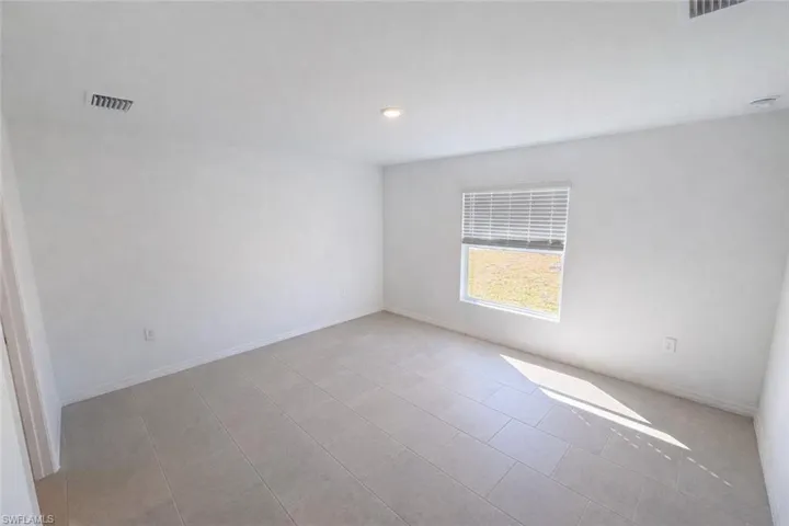 Spare room featuring baseboards