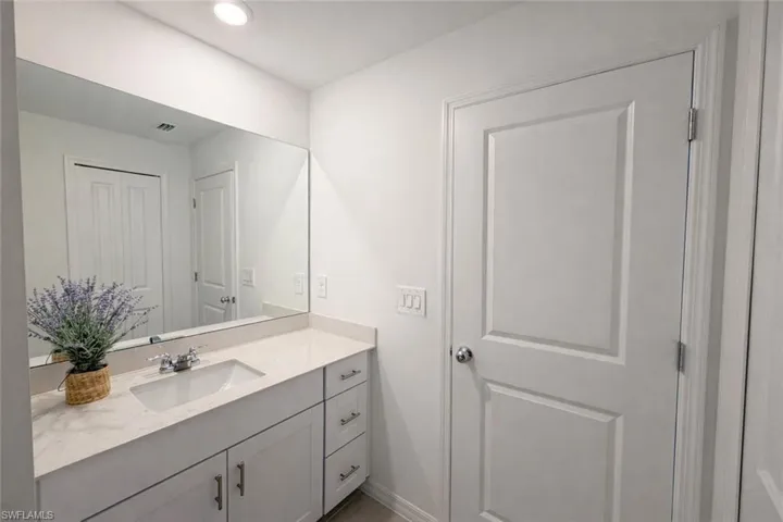 Bathroom featuring vanity and baseboards