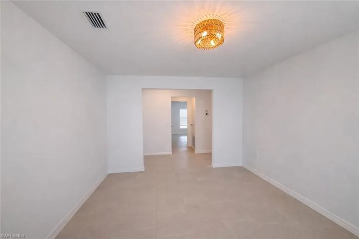 Empty room featuring baseboards