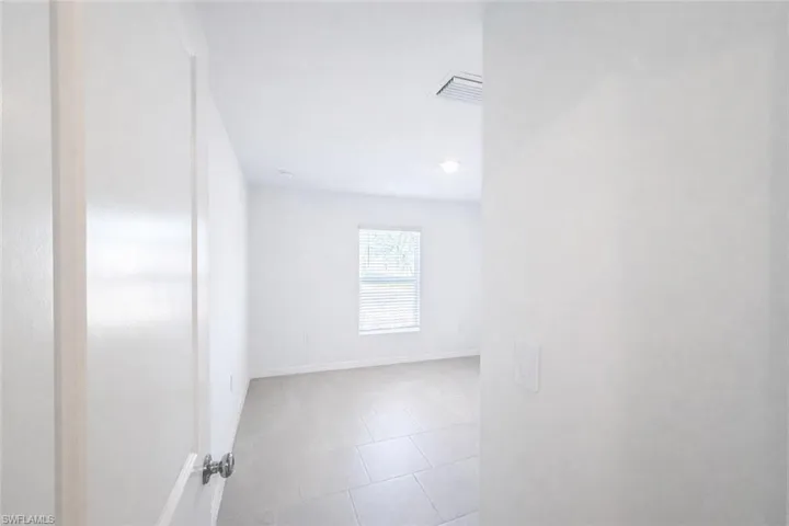 Unfurnished room with baseboards and light tile patterned floors