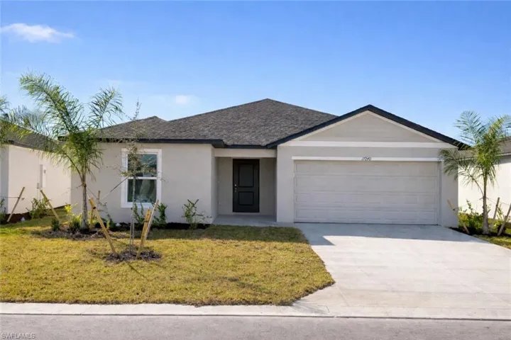 Single story home with a garage, concrete driveway, a front lawn, and stucco siding