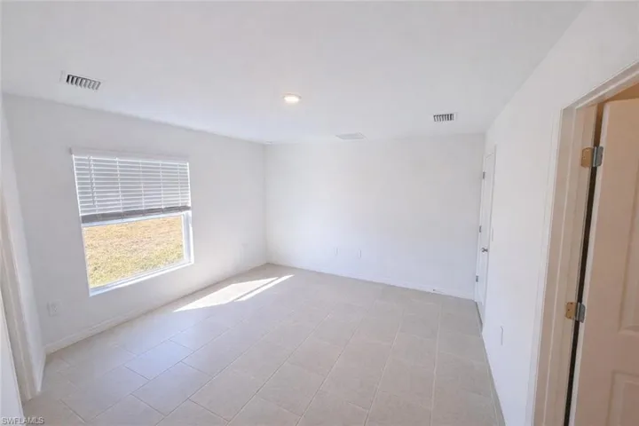 Spare room featuring baseboards