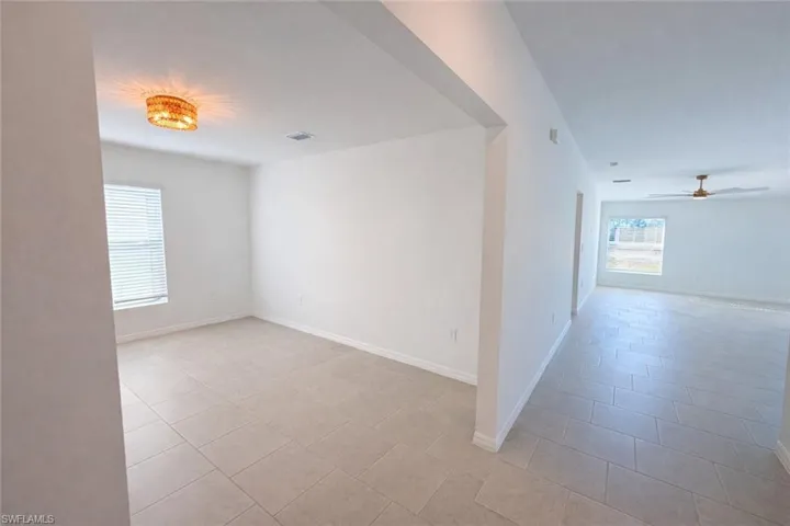 Unfurnished room featuring ceiling fan and light tile patterned floors