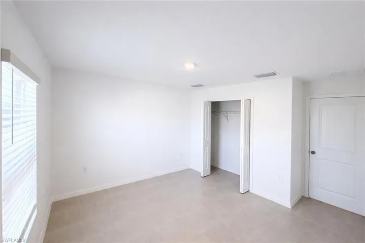 Unfurnished bedroom with a closet and baseboards
