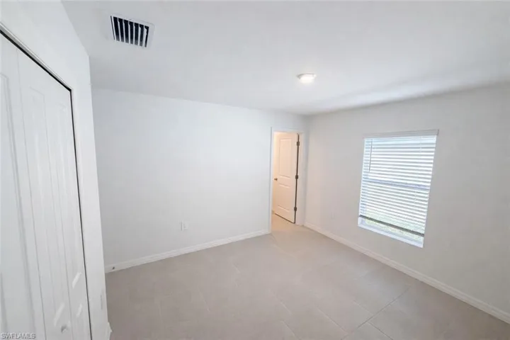 Unfurnished bedroom with a closet and baseboards