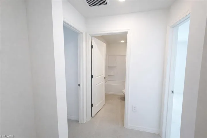 Hallway featuring baseboards