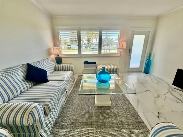 Tiled living room featuring ornamental molding