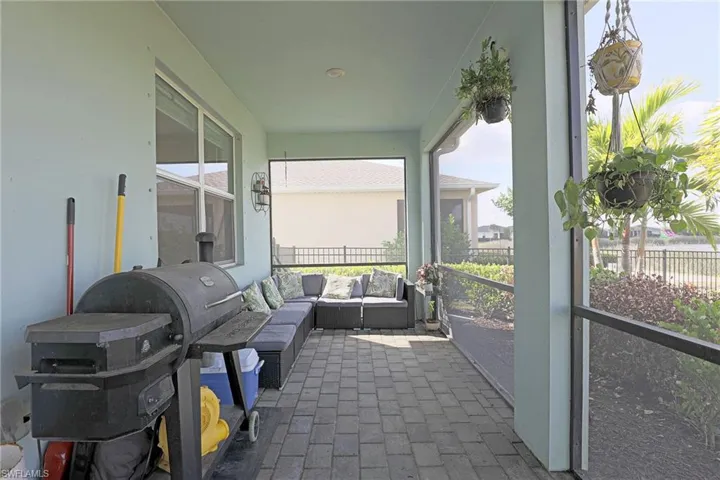 View of patio featuring a sunroom, area for grilling, and an outdoor lounge area