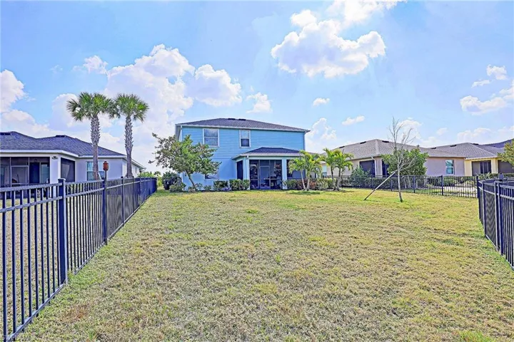 Back of property with a sunroom and a fenced backyard