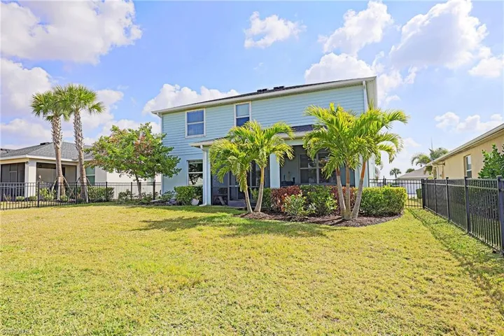 Rear view of property featuring a fenced backyard
