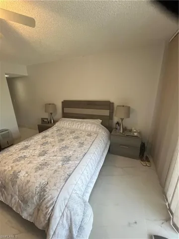 Bedroom featuring a textured ceiling and ceiling fan