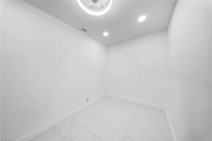 Empty room featuring recessed lighting and light marble finish floors