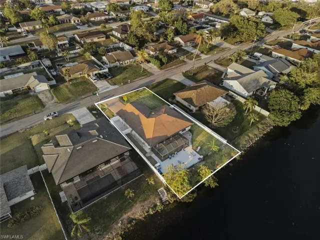 Aerial view of residential area featuring property boundaries highlighted