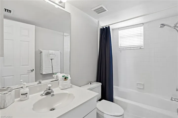 Bathroom with shower / tub combo and vanity