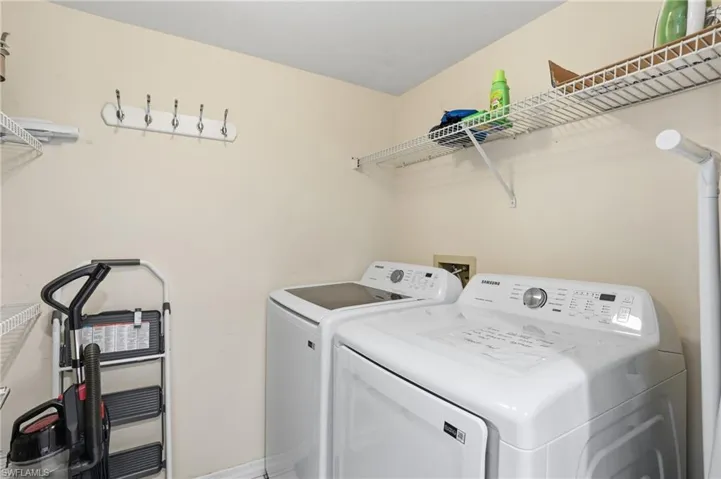 Laundry room with washer and dryer and baseboards