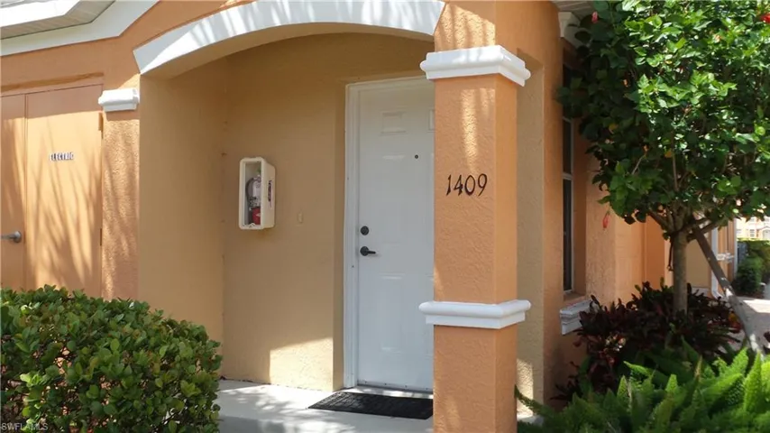 View of exterior entry featuring stucco siding
