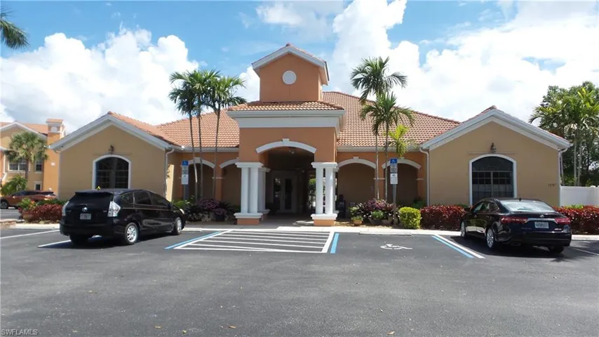 View of building exterior featuring uncovered parking