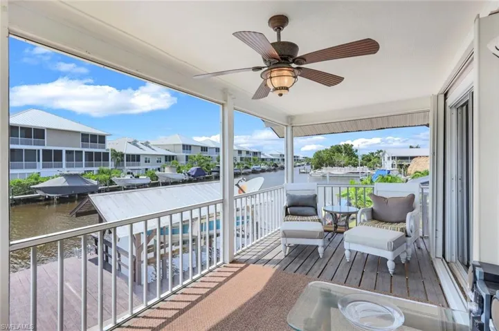 Balcony with a water view and ceiling fan