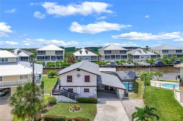 Aerial view of residential area featuring a nearby body of water