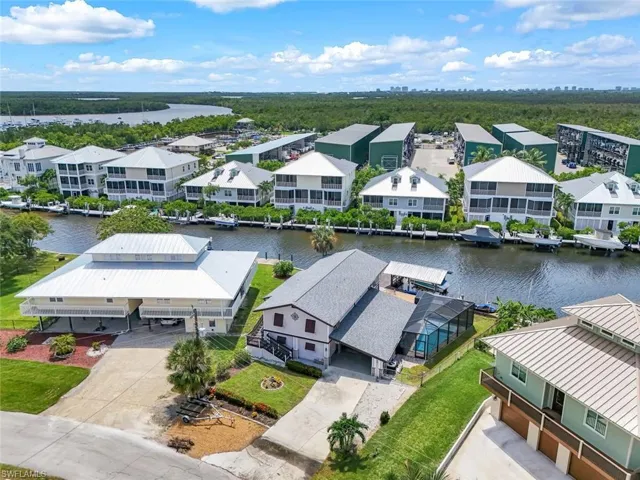 Aerial perspective of suburban area featuring a nearby body of water