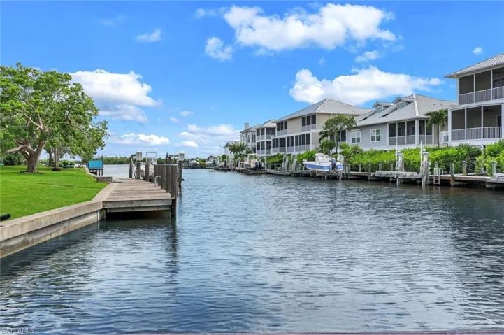 Dock with a water view and a residential view