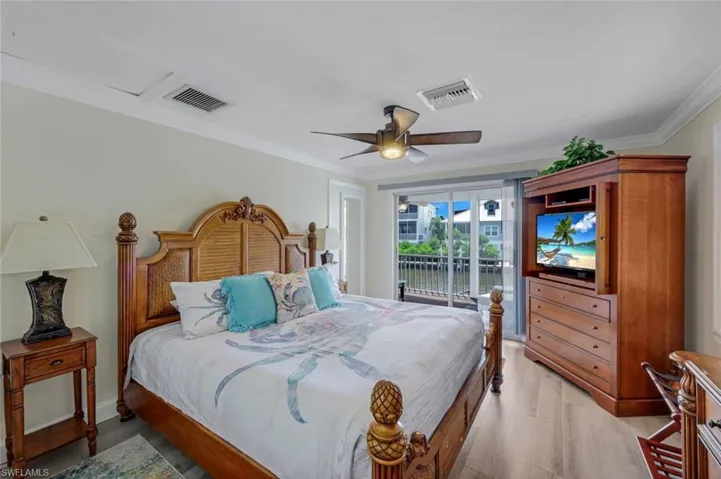 Bedroom featuring light wood-style floors, access to outside, ornamental molding, and ceiling fan