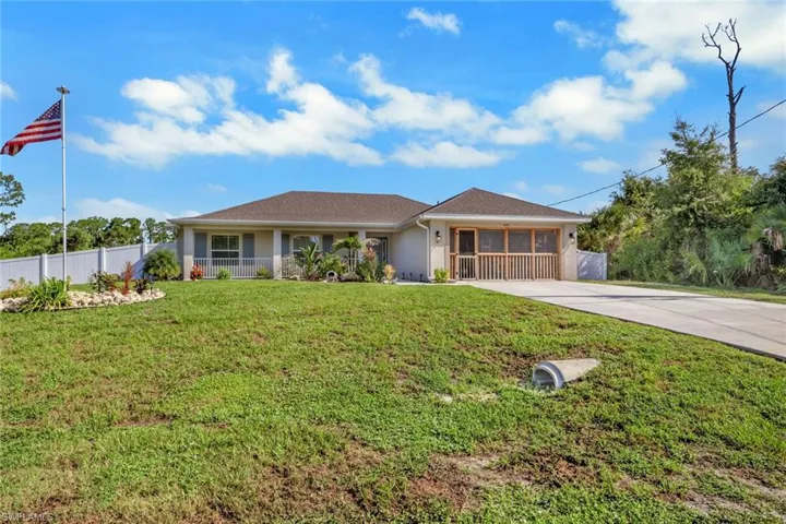 Single-story residence featuring a screened front porch, a well-maintained front lawn, and a concrete driveway