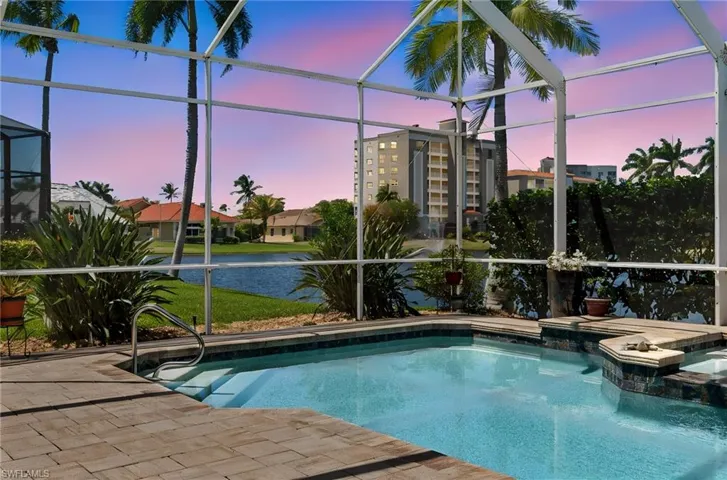 Experience breathtaking sunsets each evening from this reimagined masterpiece, complemented by a beautifully resurfaced pool, new pool deck pavers, and updated tile and coping for a refined outdoor retreat.